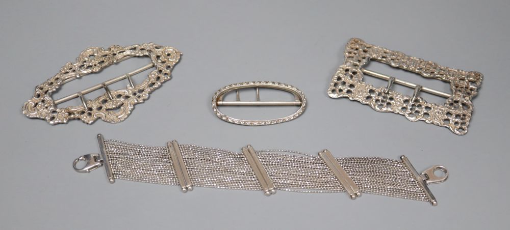 Three silver belt buckles and an Italian silver bracelet.